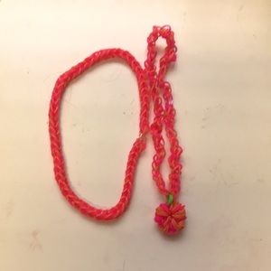 choker fishtail necklace is orange and pink orange and same has flower attached